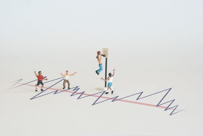 Small model figures climbing on a graph